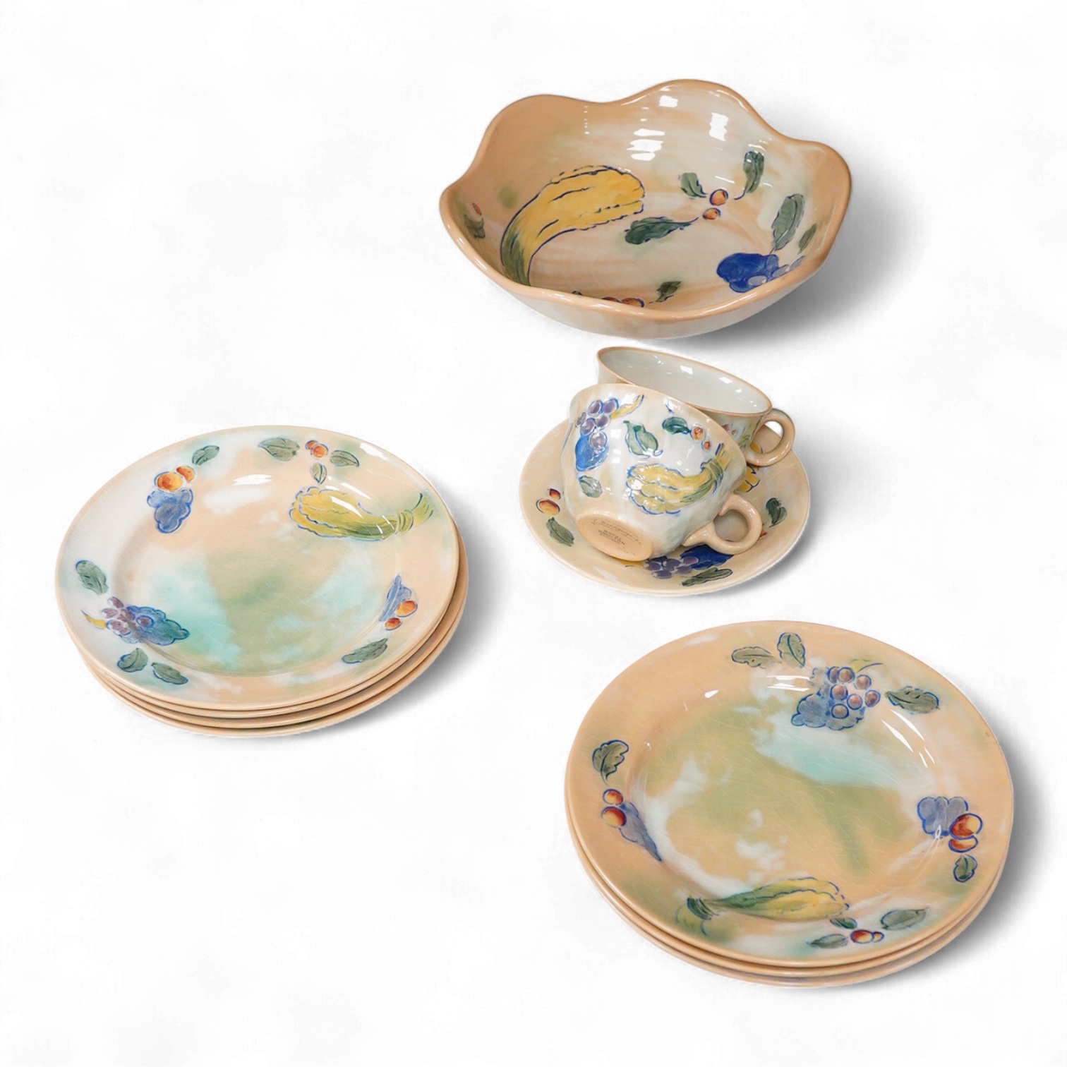 A collection of Doulton Brangwynware to include a bowl, two teacups and seven side plates, largest 34cm in diameter